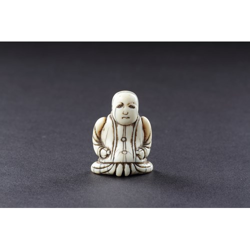Japanese Ivory Netsuke of a Dutch Merchant Kneeling in his Buttoned Coat and Baggy Trousers